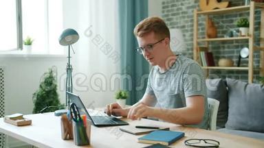 在家学习的男<strong>学生</strong>使<strong>用笔记本电脑</strong>打字，然后<strong>用笔记本电脑</strong>写作